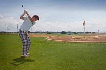 Person playing golf at Searles Norfolk Country Park